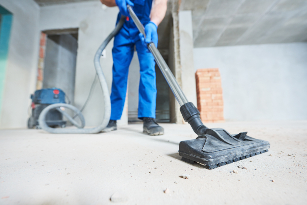Professional cleaner vacuuming while conducting construction clean-up.